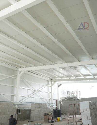 Commercial PEB steel structure with wide-span roofing by Amudha Decors