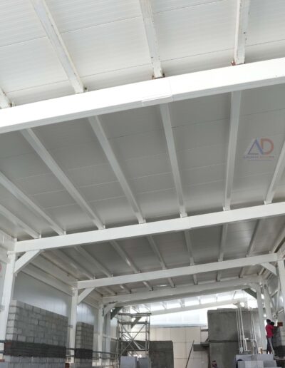 Wide-span PEB roofing for manufacturing unit by Amudha Decors