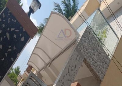 Modern tensile canopy installed at residential home entrance by Amudha Decors