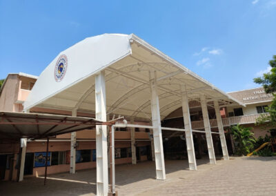 White tensile roofing structure installed at Thangamani School providing a durable weatherproof covered assembly area for students.