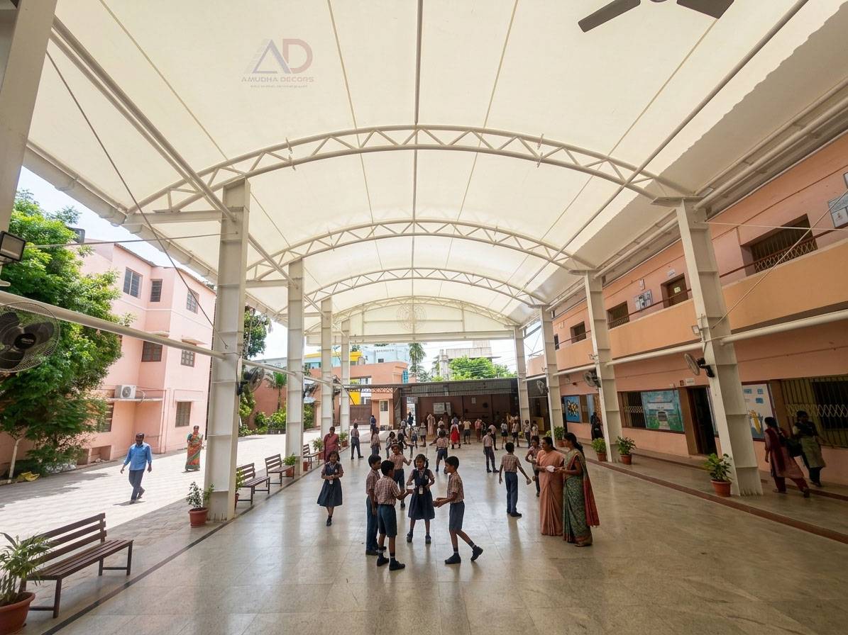 nterior view of tensile membrane roofing covering the school courtyard at Thangamani School with steel structural framework.
